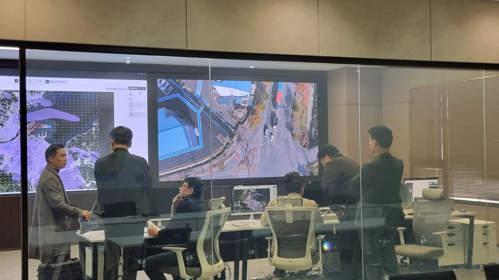 People reviewing map information in a control room